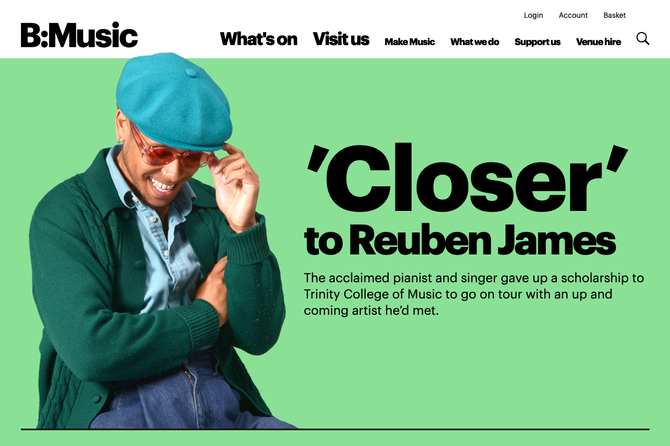 Under BMusic's white website header is a green background. On the background is a cut-out of artist Reuben James tilting his cap. A big title to the right reads "'Closer' to Reuben James." Smaller text below: "The acclaimed pianist and singer gave up a scholarship to Trinity College of Music to go on tour with an up and coming artists he'd met."