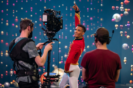 Scottish Ballet First Artist Jerome Anthony Barnes in 'nutcracker' soldier costume dances in front of a film camera and crew