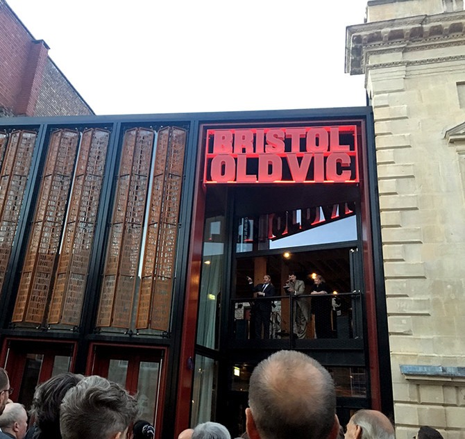 Tom Morris, Emma Stenning (and a BSL interpreter, left) give a speech from the balcony, just before the big reveal