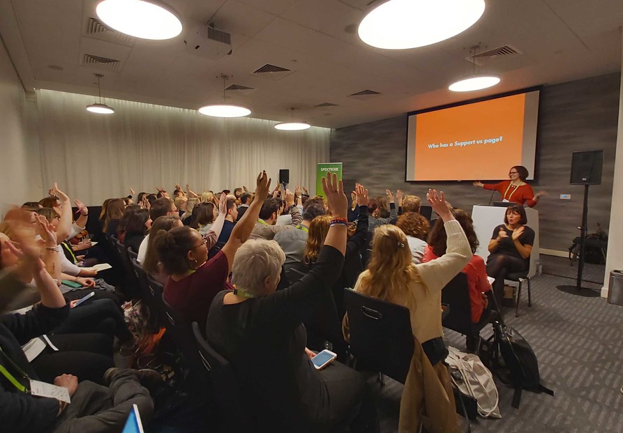 A presenter asks a room full of people 'Who has a Support Us page?' and everyone has their hands up